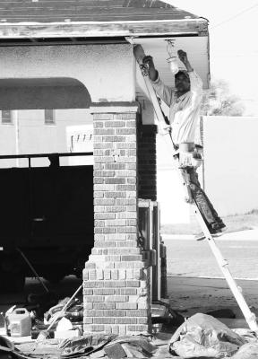 CREWS with Terrazas Roofing of Grand Island were busy last Tuesday putting a new roof, fascia, and soffit on the Royal Coachmen Car Club’s clubhouse on the corner of Indian and Seventh streets in St. Paul. Photo by Michael Rother