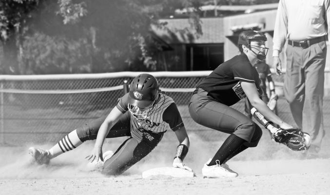 ST. PAUL’S ADDY WEGNER attempts to catch a Central City baserunner stealing second base during last week’s LouPlatte Conference semifinal game between the Central City Bison and the St. Paul Wildcats. Photos by Michael Happ