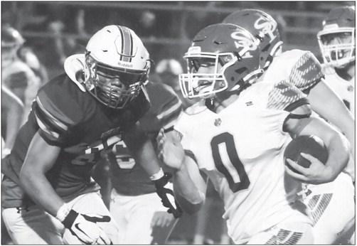 ST. PAUL Junior Gage Sack attempts to skirt past the Aurora defense on his way upfield during Friday night’s game between the Wildcats and the Huskies. Photo by Michael Happ