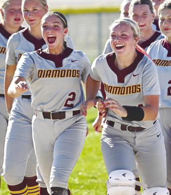 MEMBERS of the Centura softball team, including Lauren Suntych and Emma Jacobs race to receive the championship plaque last week. Photo by Michael Happ