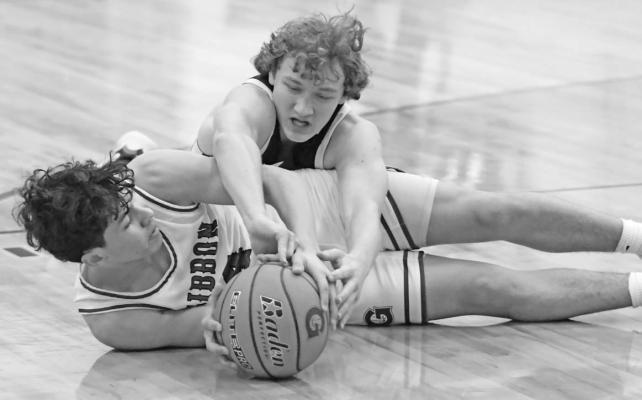 CENTURA’S JASON FANTA fights for a loose ball during the second quarter of Friday night’s game between Centura and Gibbon. The Centurions topped the Buffaloes 52-47. (Michael Happ)