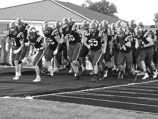 MEMBERS of the Centura High School football team charge on to the field prior to last week’s district matchup with the Amherst Broncos. The Centurions used two unanswered second half touchdowns to top the Broncos 16-7. Photos by Michael Happ