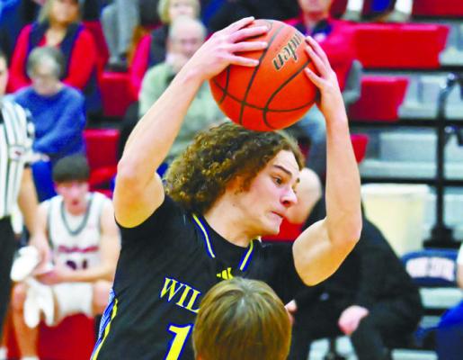 ZANDYN WELLER battles into the lane during the first quarter of last Tuesday night’s game between the St. Paul Wildcats and the Adams Central Patriots. Photos by Michael Happ