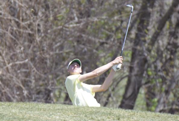 ST. PAUL junior Sam Wells watches his shot on to the eighteenth green at Centura Hills Golf Course last Thursday. Wells won the individual title at the LouPlatte Conference meet after he shot a seventy-six. (Michael Happ)