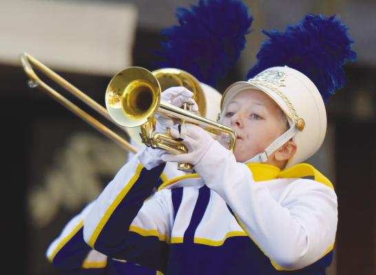 AREA BANDS participated in the Grand Island Area Chamber of Commerce’s Annual Harvest of Harmony Parade and Field Competition on Saturday morning in downtown Grand Island. Among the many bands from across the state that took to the streets last week were those from St. Paul and Centura. Above, St. Paul’s Delaney Jennings hits the right notes while making her way up Second Street. At left, members of the Centura High School Marching band performed for the crowd.