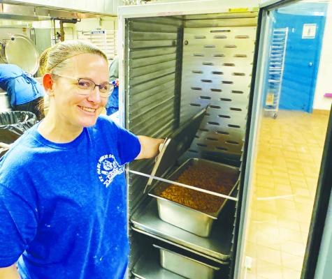 ST. PAUL HEAD COOK MIA RASMUSSEN shows off the goulash that was made last Tuesday using beef that was purchased with grant dollars the school district received through the Lunch For Schools program. Photo by Michael Happ