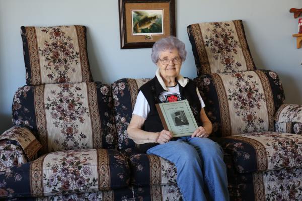PEGGY NEALON sits with her mother’s book of “Elementary Rivet Theory” from the Ford Airplane School near Yspsilanti, Michigan, which trained factory workers in the assembly of B-24 Liberators as part of the war effort. (Michael Rother)