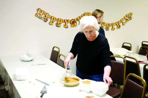 UTÈ WOJTALEWICZ was in charge of dishing up pies at this year’s community Thanksgiving. She was one of many community members to volunteer their time in preparation for the meal.