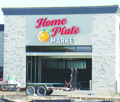 WORKERS officially put a name to St. Paul’s new grocery store over the weekend, as signage was hung on the future site of Home Plate Market on the corner of Second and O streets in St. Paul. The market, which is set to open late this fall, went ver tical at the start of the year. Crews have been working on the project since last fall. Photo by Michael Rother