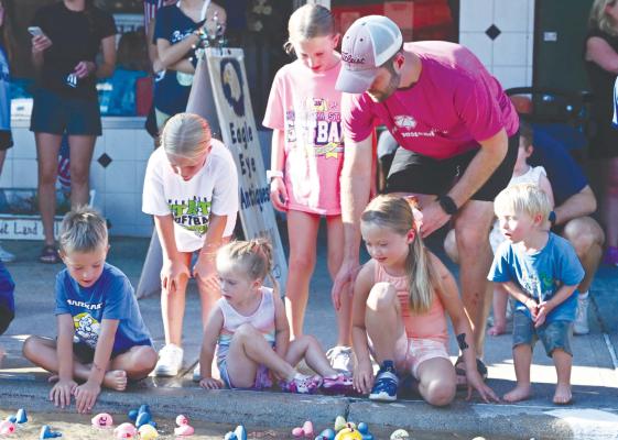 WATCHING THE DUCKS make their way down Howard Avenue on Friday are Jack Meyer, Harper Synowski, Millie Meyer, Emmy Platek, Lainey Meyer, and Jordan Meyer.