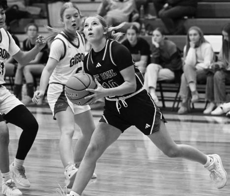 ALLI DUGAN drives into the lane for a shot during the fourth quarter of last Thursday’s season opener against Gibbon. Dugan had seven points against the Buffaloes. Photos by Michael Happ