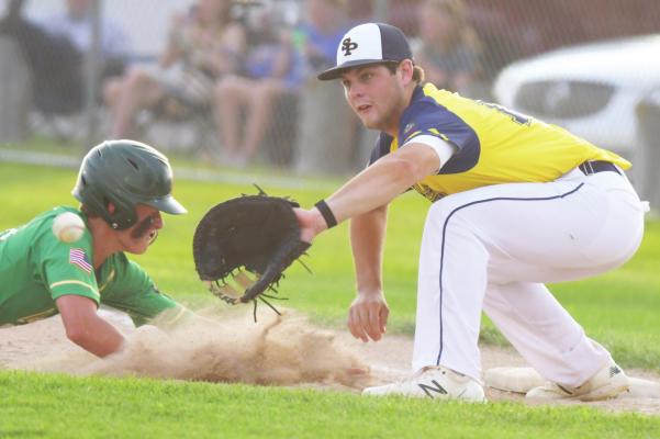 ST. PAUL’S AJAY AMBROSE attempts to pick off a Central City baserunner at first base during last Friday evening’s game at Grover Cleveland Alexander Field in St. Paul. (Michael Happ)