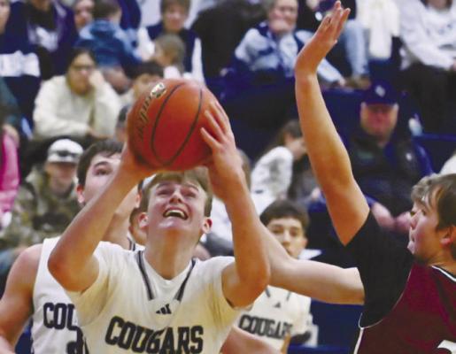 ZEVAN WOLF muscles his way to the basket during last week’s tournament championship game against Stuart. Wolf had twenty-one points in the contest. Photos by Michael Happ