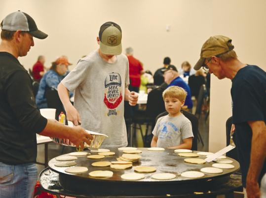 MANNING THE PANCAKE GRIDDLE on Sunday morning at the St. Paul Volunteer Fire Department’s annual pancake feed were Spencer Synowski, Isaac Meyer, Caleb Meyer, and Chad Augustyn. A large contingent of volunteers helped make this year’s feed a success. Photo by Michael Happ