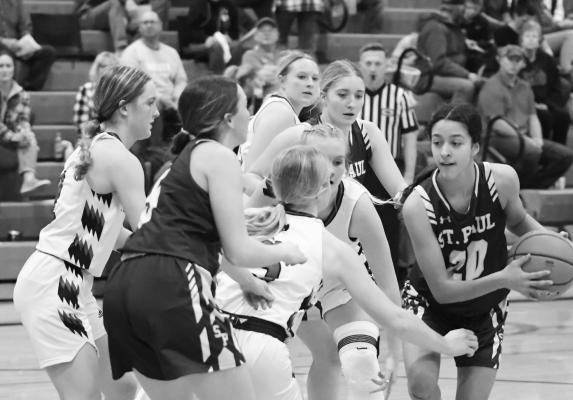 FRESHMAN Zaya Lewis dribbles past a gang of Rebel defenders on her way to the hoop on Friday night. Lewis had two points in the game. Photos by Michael Happ