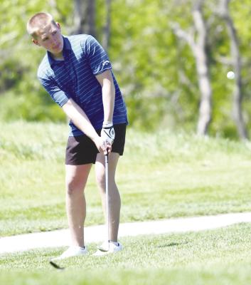 ST. PAUL’S SAWYER KAVAN chips on to the green at Meadowlark Hills in Kearney last Tuesday. The Wildcats placed fourth as a team at the Stars’ annual invitational. Photo by Jordan Coslor