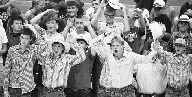MEMBERS of the St. Paul High School student body got into the action late last month during the Wildcat volleyball team’s season opener against David City High School. The students dressed in their best cowboy attire, helping the Blue and Gold lasso a victory on the court. Photo by Michael Happ