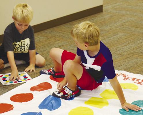 HUNTER HELMER AND KELLAN SEAMANS play a game of Twister during one of St. Paul Summer Rec’s Board Game Days, held last Wednesday, June 12th at the St. Paul Civic Center and led by Jen Meinecke. Photos by Michael Rother