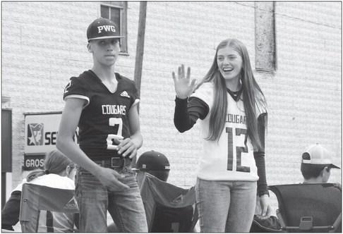 CAYLE GROSSART waves to the crowd from atop the freshman class’s float, Barbecuing the Buffaloes. Standing beside Grossart is Landon Shoemaker. Photos by Michael Rother