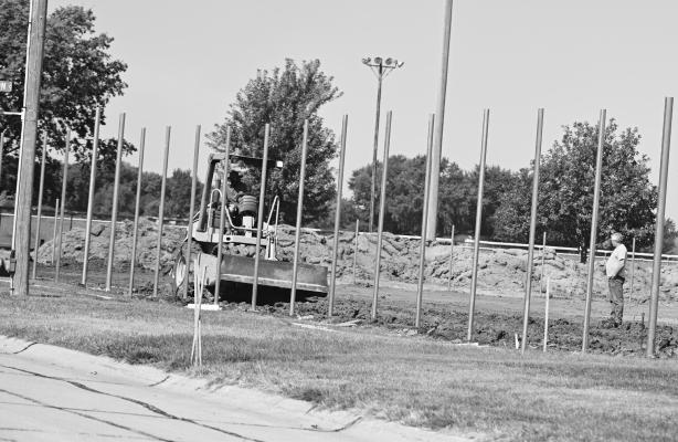 WORK continues on the City of St. Paul’s new tennis/pickleball courts on Elm Street. On Monday, crews were busy setting the poles for the fencing for the project, which is being funded through a grant from the Nebraska Department of Economic Development’s (NDED) Rural Community Recovery Program. Photo by Michael Happ