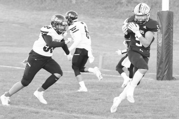 GRADY KELLEY catches a pass in the end zone for a two-point conversion during the first half of Friday night’s football game in Wolbach. Photo by Michael Happ