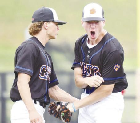 CHRISTIAN LEMBURG AND PARKER LENTZ celebrate the end of an inning following a play by Lentz at the state baseball tournament last week. Photo by Jordan Coslor
