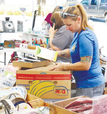 JUNKERS and vendors sift through the many items displayed for sale near the home of Alice Osterman-Davis on United States Route 281 in St. Paul during Junk Jaunt. Photo by Michael Rother