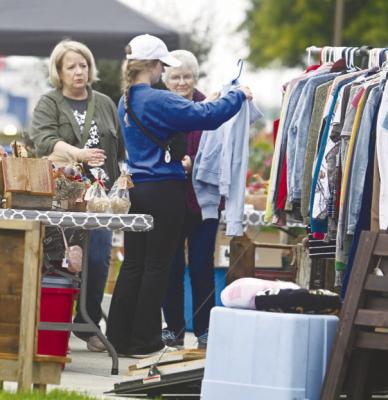 PARTICIPANTS in the twenty-third annual Junk Jaunt browse the many items being sold at the home of Alice Osterman-Davis in St. Paul on Saturday morning. Photos by Michael Happ