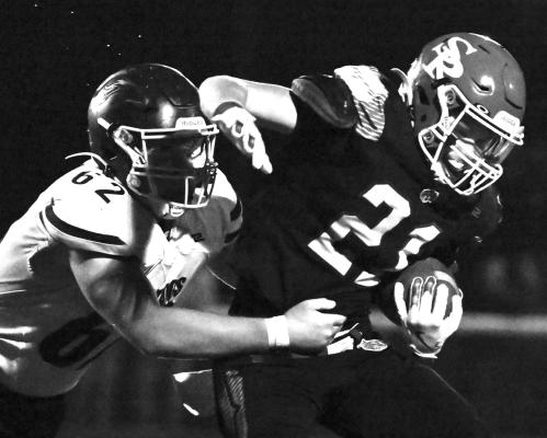 CARTER HAWLEY works to shake loose a Mustang defender during one of his four runs against the Mustangs. St. Paul racked up 138 yards rushing on the ground last week during its home opener against Raymond Central. Photos by Michael Happ