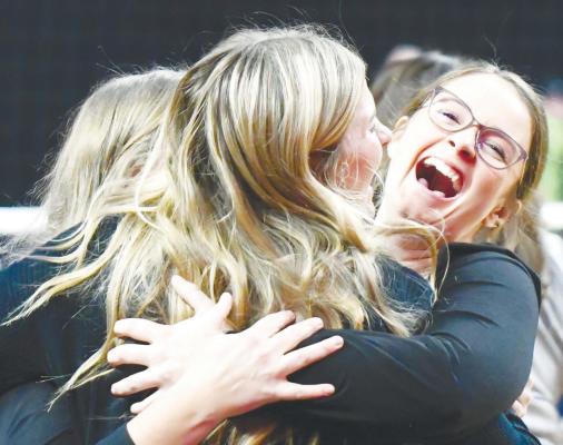 ST. PAUL HIGH SCHOOL alumna Madalynn Fousek embraces her assistant coaches following the Bobcats’ victory over undefeated Southwest in the semifinals of the Class D-1 state tournament. Photo by Jordan Coslor