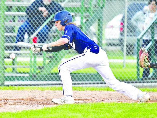 ST. PAUL’S ZANDYN WELLER drives home the first run of last Wednesday night’s game against Central City with a bunt single. The St. Paul Seniors bested Central City 4-0. Photos by Michael Happ