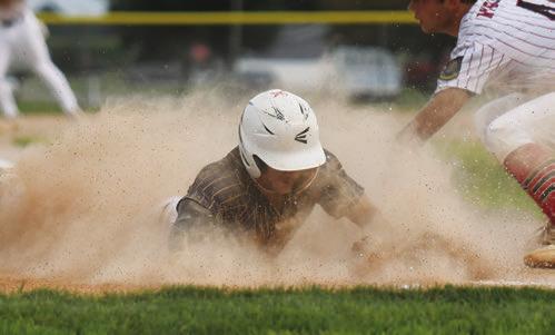 COLBY WOOD beats the tag, sliding safely into home plate after a wild pitch in the first inning of St. Paul’s second game with Ord.