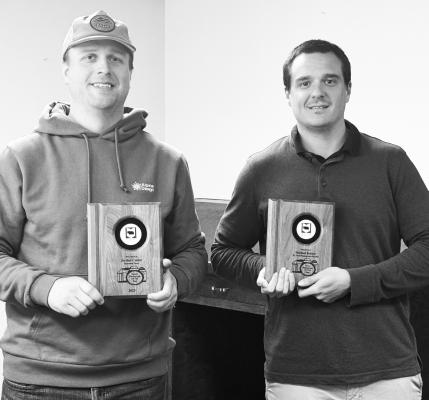 SHOWING OFF THEIR ALL-CLASS AWARDS from the Nebraska Press Association’s Better Newspaper Contest are Jordan Coslor and Michael Rother. Coslor was honored with the Sports Photo of the Year in the contest; Rother was honored for the News Photo of the Year. Photo by Michael Happ