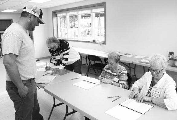 VOTERS in Greeley County’s Wolbach Precinct took to the polls shortly after they opened at 8:00 a.m. for the May 12th Primary Election. Above, Matt Steenson talks to poll workers Rhonda Allen, Jan Steenson, and Donna Rother as he prepares to cast his ballot. Photo by Michael Rother
