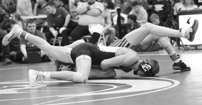 LUKE SHOEMAKER pinned Kenesaw’s Will Blez in the third period during the opening round of the district wrestling tournament at Shelby on Friday. Shoemaker finished the tournament in third place. Photos by Michael Happ