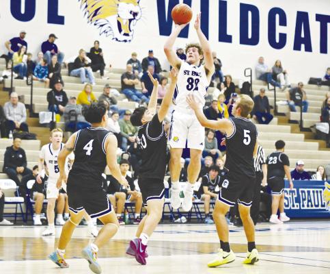 ST. PAUL senior Gage Sack floats a jumpshot in the second quarter of Thursday night’s game between St. Paul and Gibbon. The Wildcat senior had twenty points in St. Paul’s 60-29 victory. Photos by Michael Happ