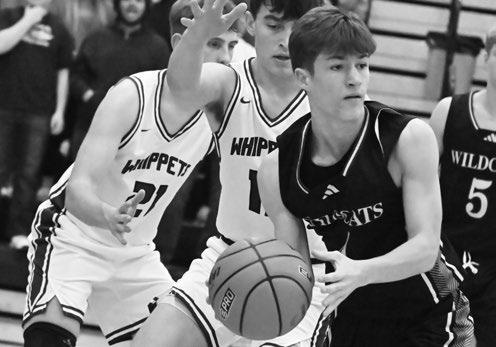 ST. PAUL’S MAX MEYER looks to kick the ball out to the perimeter during the Wildcats’ game against Minden last Tuesday night. The Whippets blistered St. Paul 58-36. Photo by Michael Happ