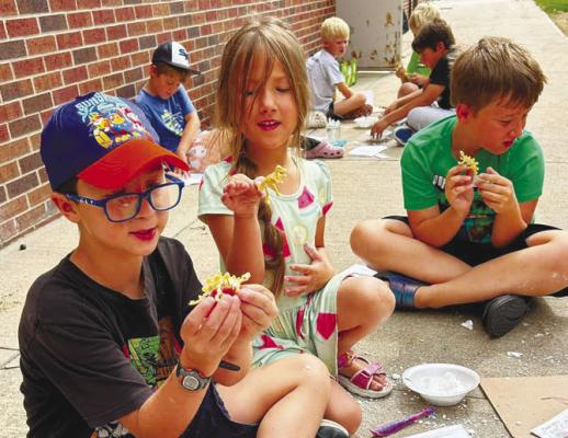 PARTICIPANTS in the St. Paul Library’s annual summer reading program worked to Unearth a Story with a multitude of crafts and activities during the month of June. Above, students show off their fossils during one of the last gatherings of the summer. Courtesy Photo