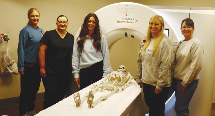 HOWARD COUNTY MEDICAL CENTER recently purchased a new CT machine. Pictured with the machine in the medical center’s new CT suite are Brandie Rosander, Mariah Quiring, Autumn Wegner, Nicole Coufal, and Holly Sack. Photo by Michael Rother