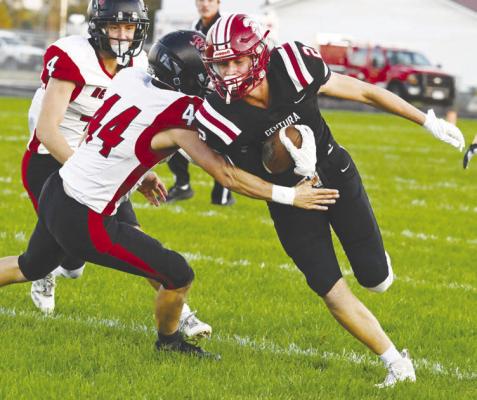 CENTURA’S FLETCHER FRIES edges past Arcadia/Loup City’s Austin Conner during Friday night’s game at Centura High School. Fries had a pair of runs in the contest, which the Centurions won 44-14. Photo by Michael Happ