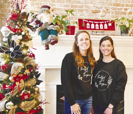 ROOTED ‘N THYME founders Allison Rubesh and Kim Joynt are pictured in the front of the fireplace inside their shop at 623 Howard Avenue in downtown St. Paul. The pair opened their home and health boutique on Small Business Saturday, November 30th. Photo by Michael Happ
