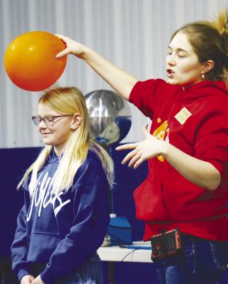 ST. PAUL third-grader Willa Miller helps Edgerton Educator Nicole Haulik demonstrate static electricity during EOTM’s Sparks demonstration last week. Photo by Michael Rother