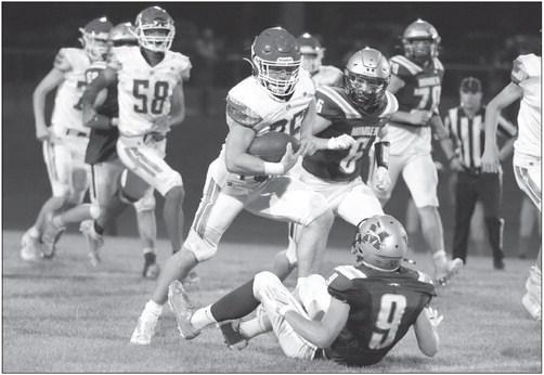 ST. PAUL’S Cody Kuszak dodges a pair of Minden defenders during the third quarter of Friday night’s game between the Whippets and Wildcats. Photo by Michael Happ