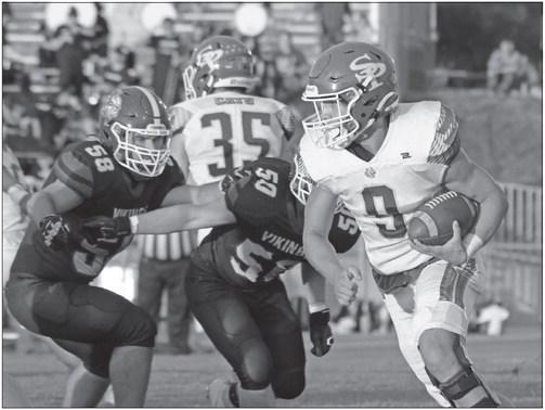 ST. PAUL’S ASHTON MEINECKE attempts to slip past a pair of Columbus Lakeview defensers during the first quarter of Friday night’s game against the Vikings. Photos by Michael Happ