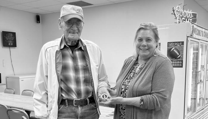 NADINE BANE recently presented a Forgotten Warrior Honorary Air Force Coin to former Second Class USAF Anton Oljen at Charlies Station in Elba last Tuesday. Courtesy Photo