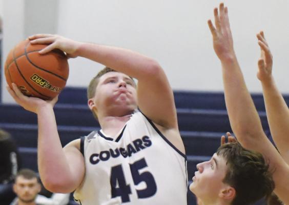CORDEL WAGNER muscles his way to the rim during the first quarter of last Thursday night’s game between Central Valley and Burwell. Wagner had fourteen points in the contest. Photo by Michael Happ