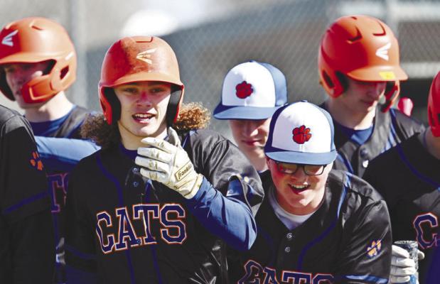 MEMBERS of the St. Paul/Palmer Cats baseball team celebrate at home plate after Zandyn Weller hit a home run on the program’s third pitch of the first game of last season. Weller’s homer last March spurred one of two runs the Cats tallied on opening day against York in St. Paul. Photos by Michael Happ