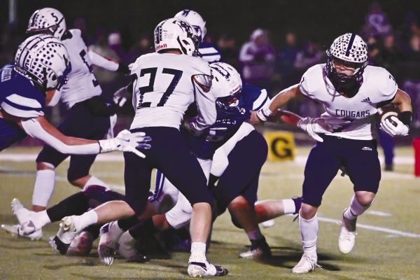 CENTRAL VALLEY Quarterback Zaden Wolf finds a seam and gets past the Defenders’ defense during Friday night’s semifinal game between the Cougars and Archangels Catholic. Wolf carried the ball seventeen times in Central Valley’s 50-8 victory. Photos by Michael Happ