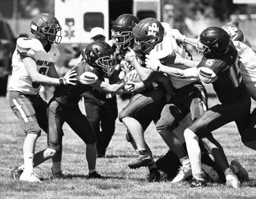 COLIN BRAHATCEK attempts to move the ball against High Plains’ defense during the first quarter of Friday afternoon’s game between the Bluejays and the Storm. Photos by Michael Happ