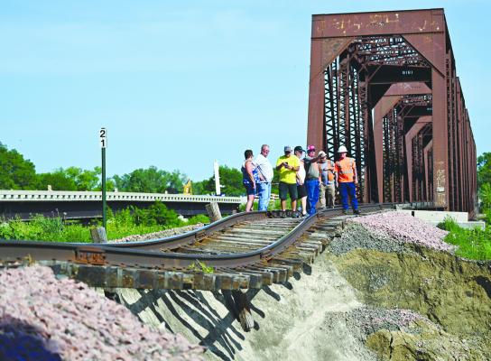 MULTIPLE STAKEHOLDERS discus the impact of high river flows while inspecting damage to the Nebraska Central Railroad line south of St. Paul on Friday. Photo by Michael Happ